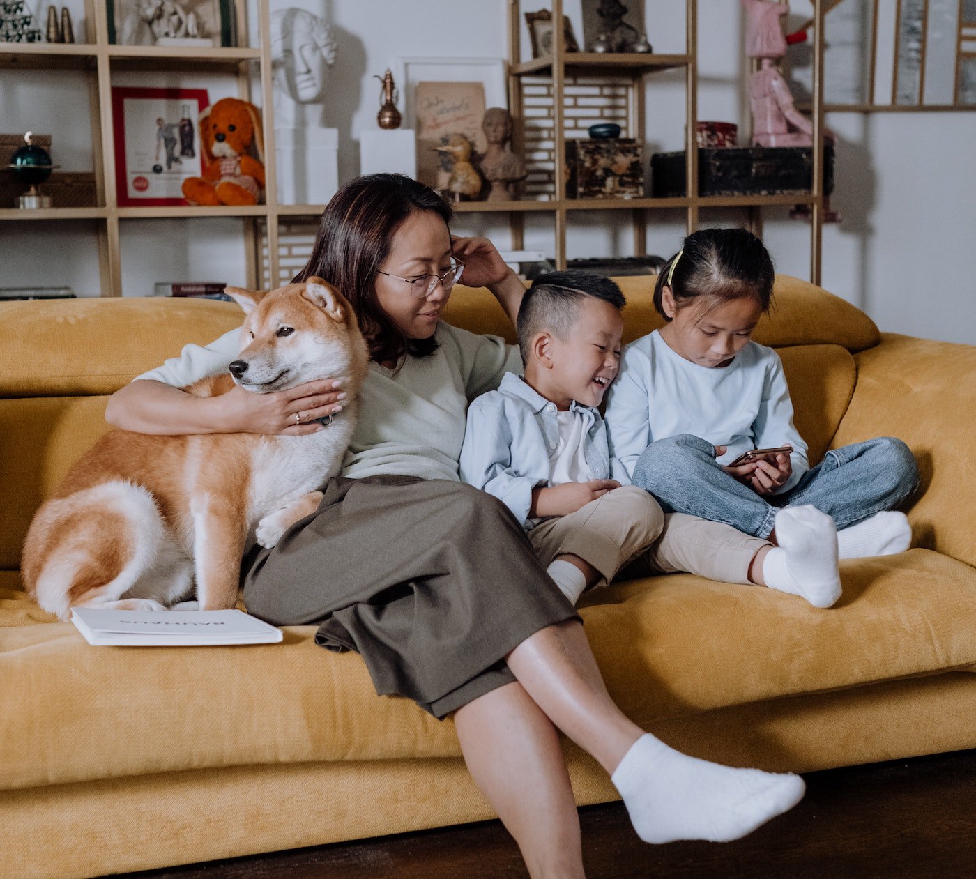 Mother and kids on the couch with their dog